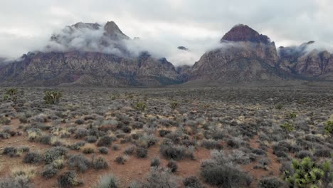 Aerial-drone-shot-of-mountains-with-low-winter-clouds