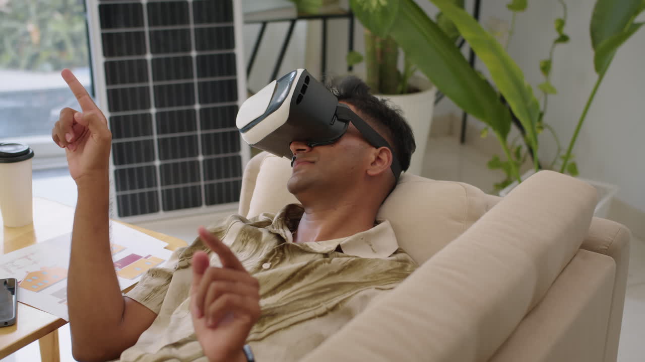 Engineer Checking App in VR Headset, Lying on Sofa at Office