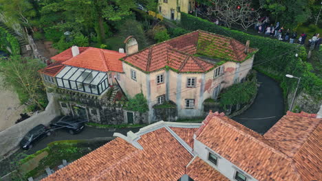 vintage buildings surrounded trees at old village landscape drone shot.