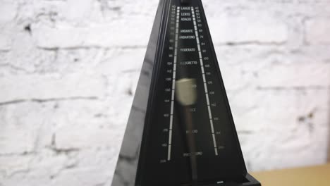 antique metronome with pendulum in slow motion. vintage wooden classic style. equipment of music, beat, rhythm mechanism. 4k video footage