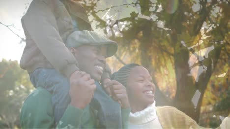 animation of happy african american family walking outdoors in nature and smiling, over forest