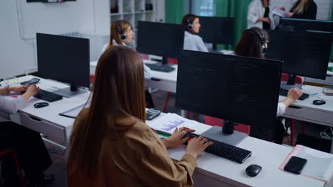 women working at desk with laptops