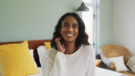 portrait of happy biracial woman smiling and looking at camera