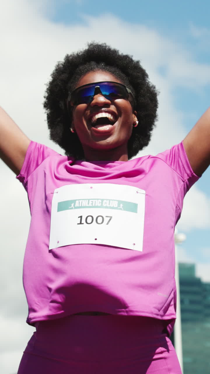 Happy Female Athlete Cheering with Arms Raised in Victory