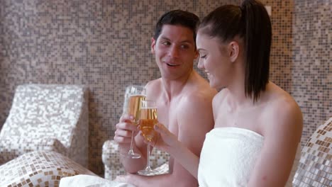 couple toasting with champagne in the spa