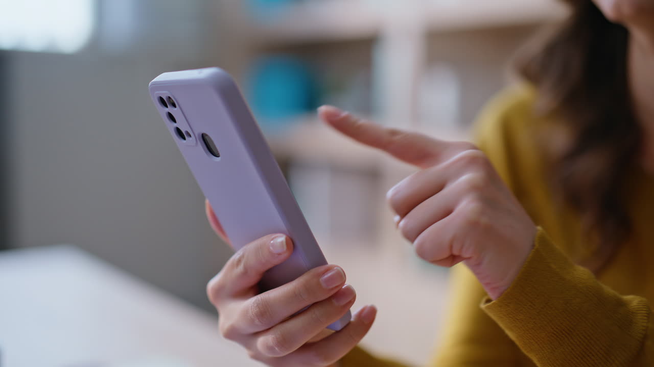 User hand pointing smartphone searching information online at home closeup