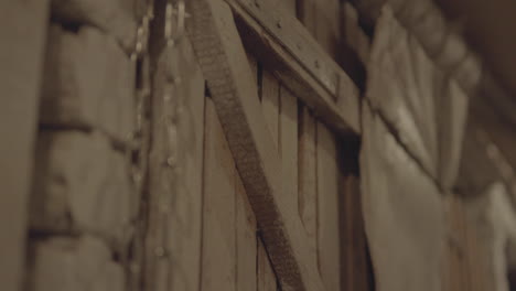 Close-up-of-aged-wooden-ladder-leaning-against-a-textured-stone-wall,-warm-lighting,-evoking-a-sense-of-history,-work,-and-the-passage-of-time-in-a-rustic-setting