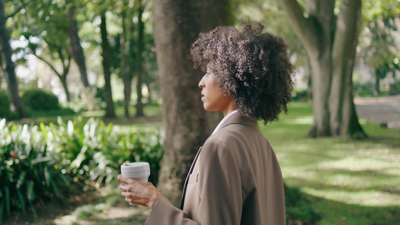 Woman walking park coffee in paper cup close up. Business lady hurrying on work.