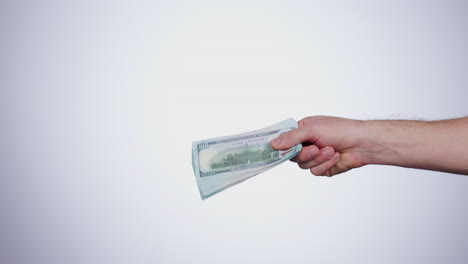 Hand,-payment-and-closeup-of-money-in-a-studio