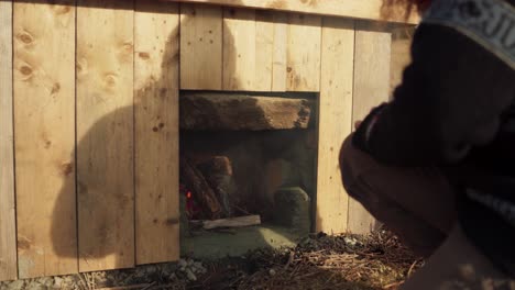 A-Man-is-Burning-Firewood-Beneath-the-Homemade-Hot-Tub---Close-Up