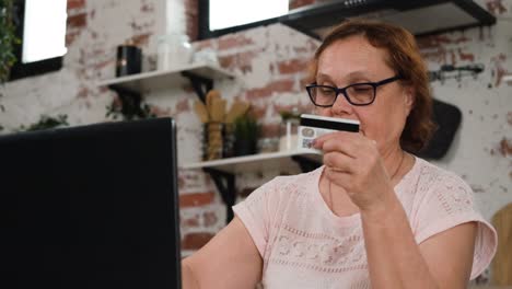elderly female paying online by credit card