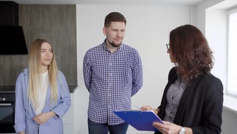 man and woman communicating with homeowner while renting or buying