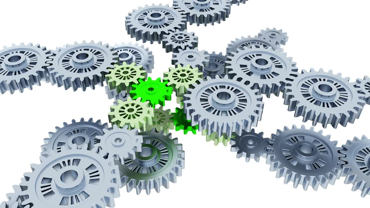 무한 회전의 은색 기어가 작은 녹색 기어에 초점을 맞추고 있습니다.