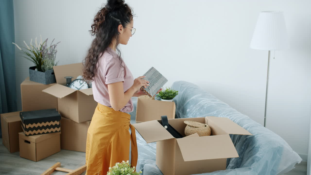 Woman Packing Boxes During a Move