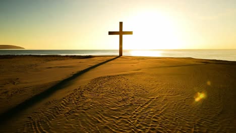 cross on a sunrise beach