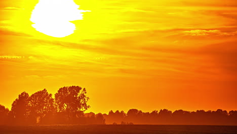 timelapse of a hot red sunset between the clouds in the countryside