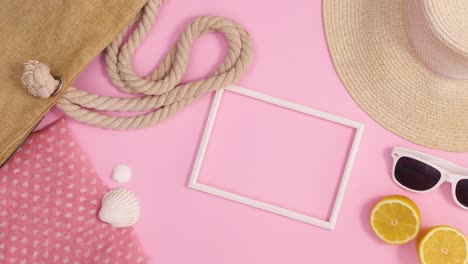 summer beach bag, hat and accessories move on pastel pink background. stop motion flat lay