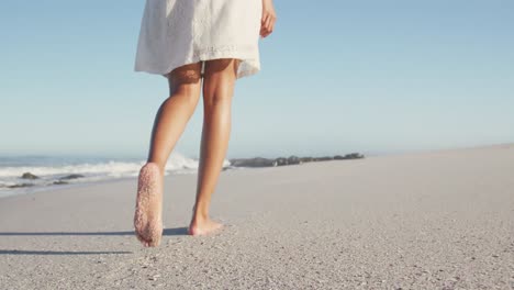 african american woman walking seaside