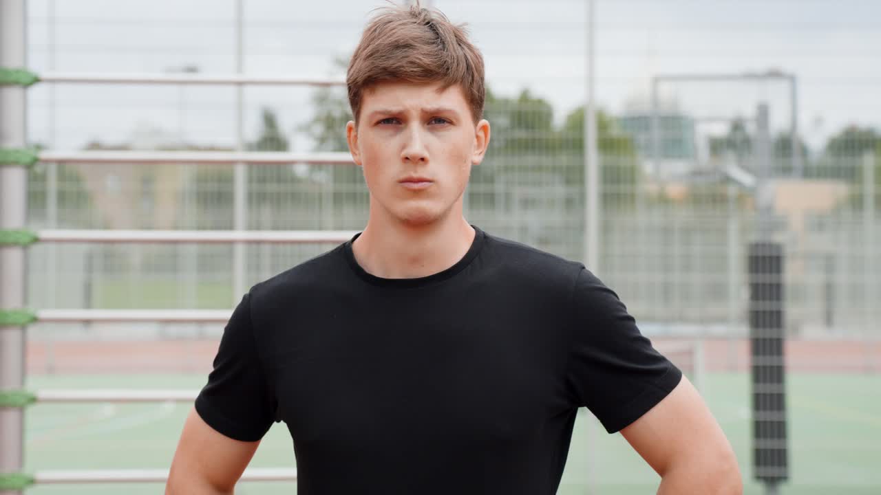 Portrait of a young man looking directly at the camera with a neutral expression post-injury