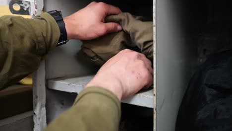 soldier picking up hidden practice grenade from the shelf