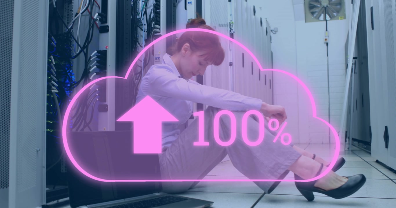 IT Professional Sitting on Floor in Server Room with Cloud Upload Progress