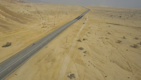 aerial pan over highway leading into the negev eilat desert in israel