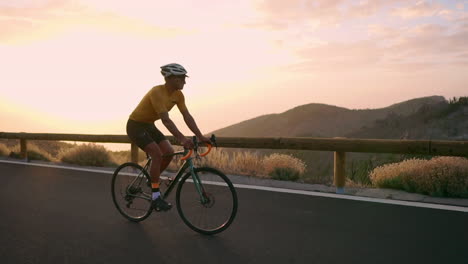 the biking athlete journeys along a mountain serpentine in slow motion, marveling at the island's view—a manifestation of a healthy lifestyle