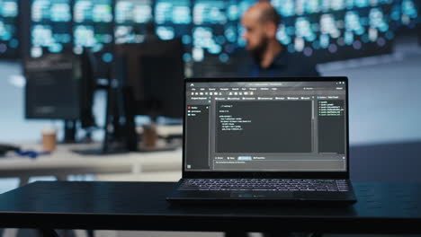 Close up shot of code lines on notebook display in data storage facility