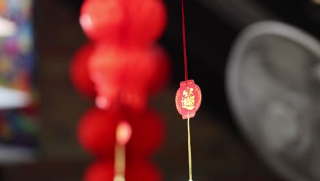 red lanterns gently swaying in the breeze, captured in vibrant detail against a blurred background in phuket, thailand