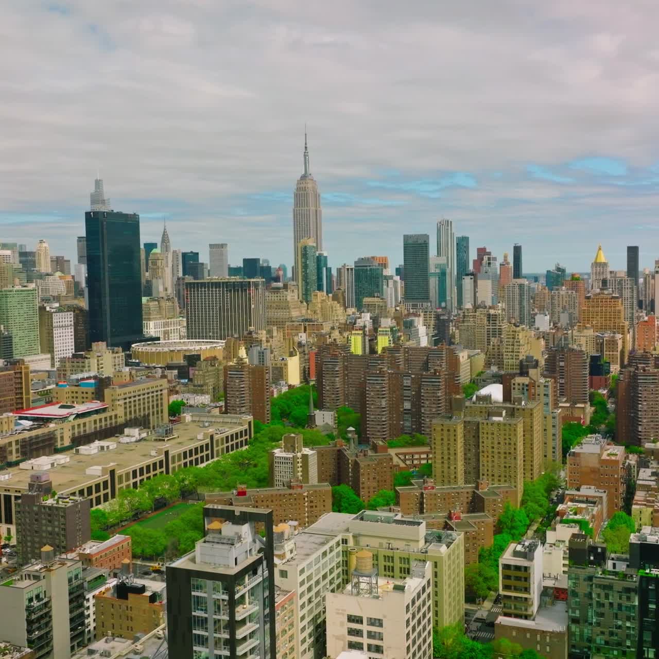 Diverse buildings in New York panorama. City combining usual structures with skyscrapers and green parks. Top view