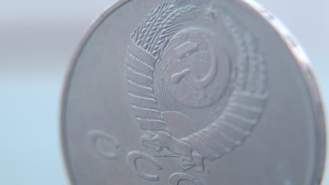 hyper macro shot of an old metal russian 5 ruble coin, cccp sssr symbol, front side, vintage money, slow cinematic 4k video pan left