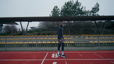 man training on a track at stadium