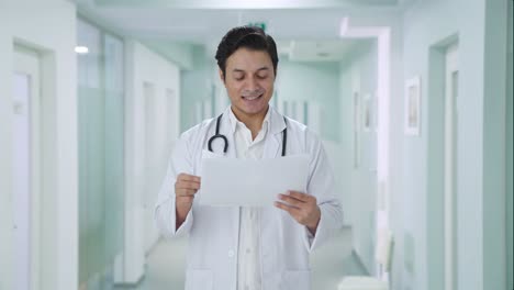 happy indian doctor checking medical reports