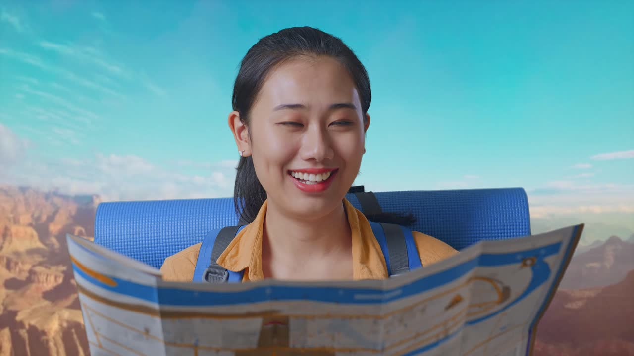 Close Up Of Asian Female Hiker With Mountaineering Backpack Looking At The Map Then Smiling To Camera While Traveling At The Top Of Mountain
