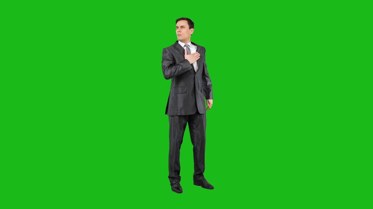 Man in suit with hand over heart on green screen