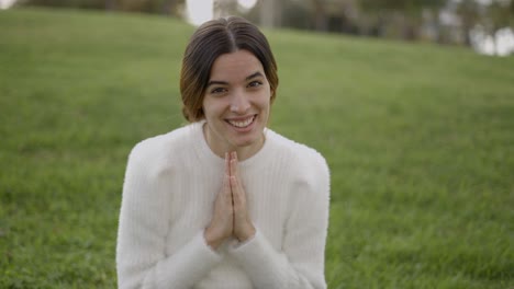 woman praying in a park