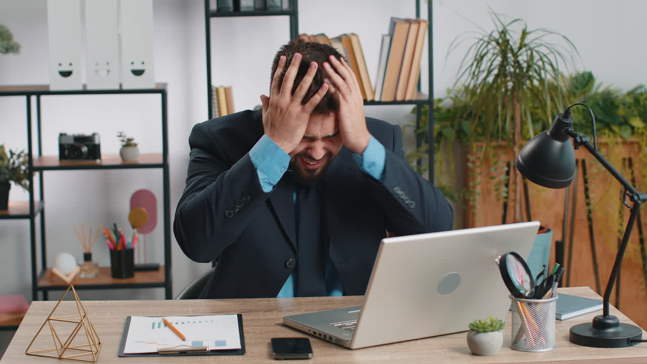 Irritated tired businessman working on laptop website problem computer virus data loss by hacking