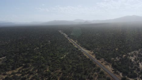 aerial view cars driving on desert road with mountains in baja, mexico