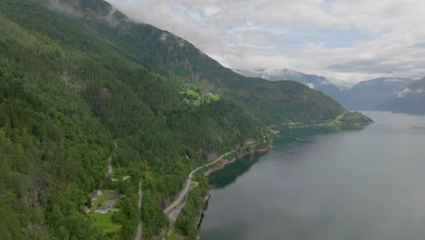 aerial view of scenic road hugging the impressive hardanger fjord, norway