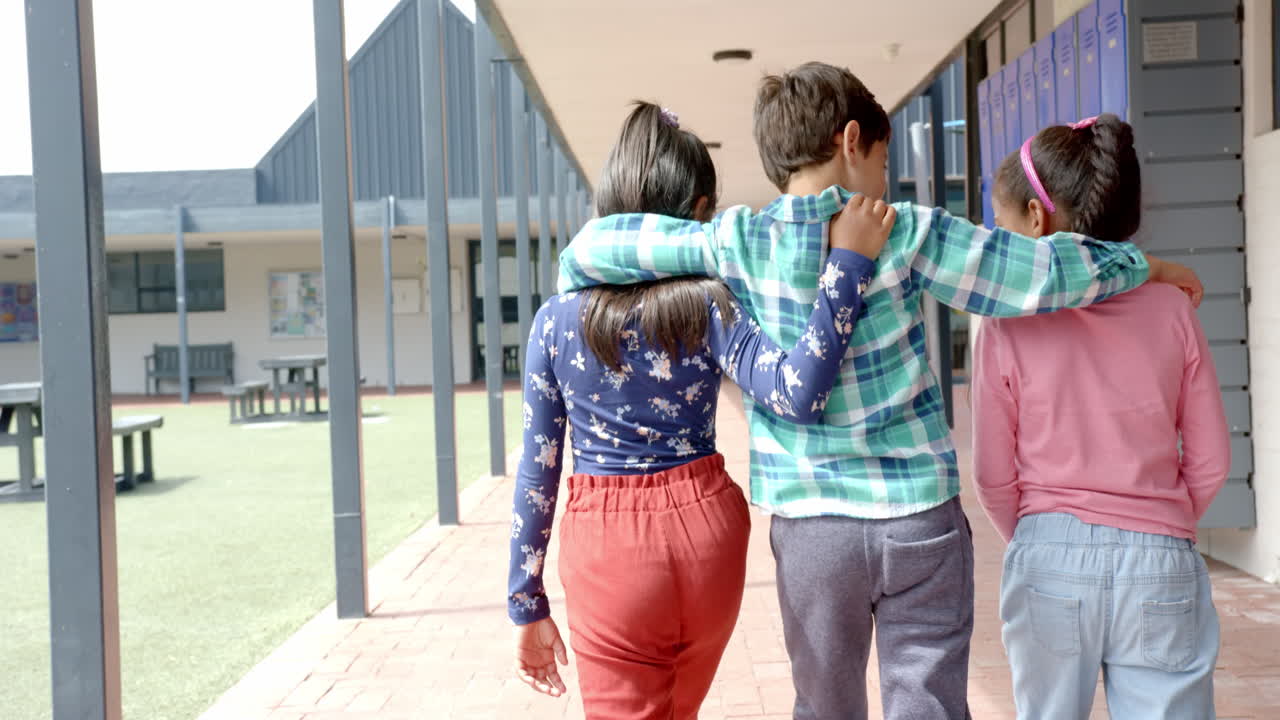 In school, three young friends are walking together