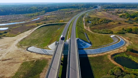 aerial road traffic. aerial view road above river landscape. highway landscape