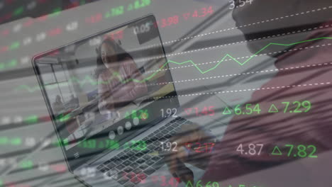 animation of stock market data processing over african american man having a videocall on laptop