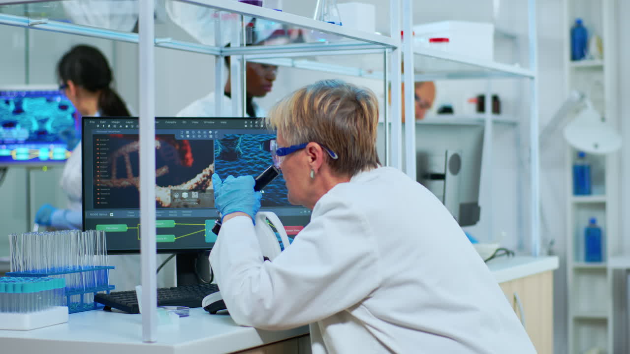 Senior scientist looking through a microscope in a laboratory