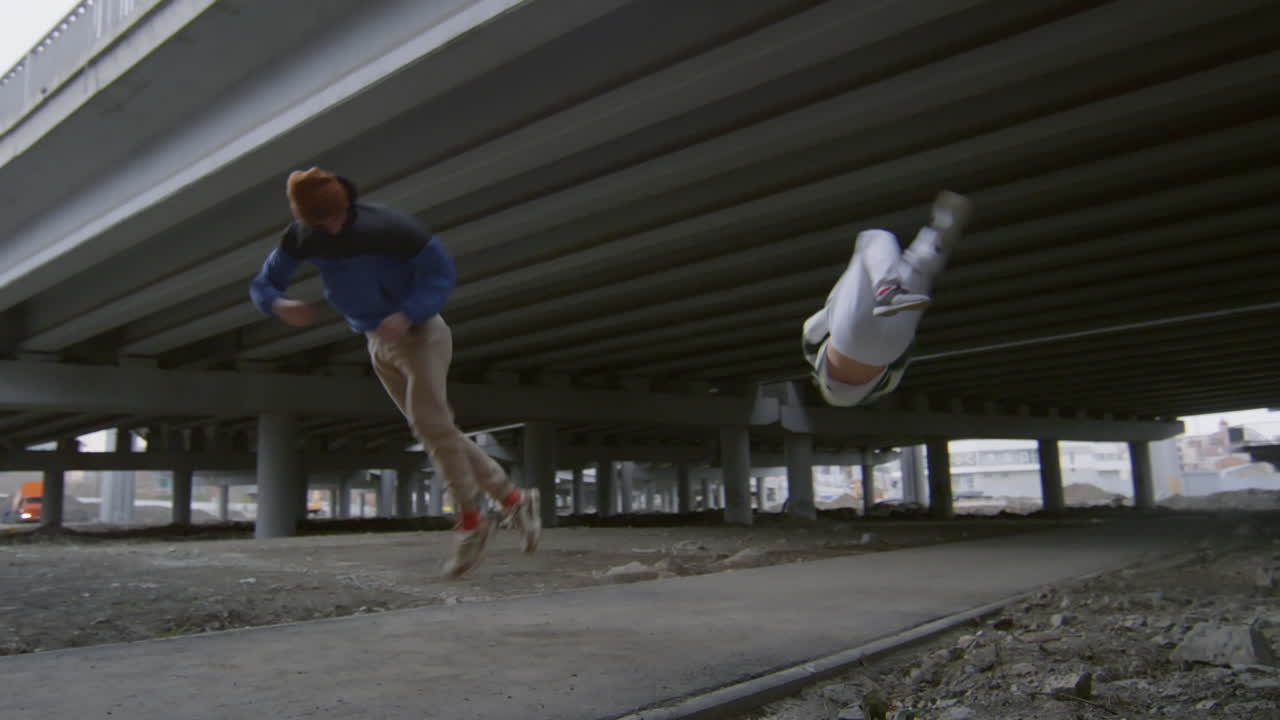 Two Guys Performing Epic Parkour Stunt on Street