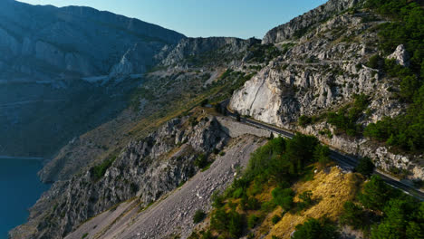 drone following a mountainous road on the makarska riviera, sunny day in croatia