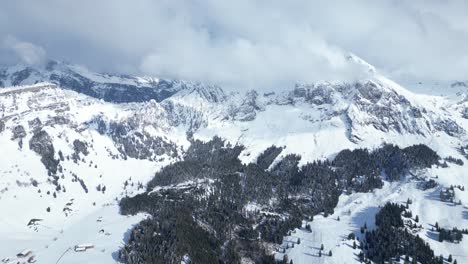 Aerial-shot-of-beautiful-Fronalpstock-mountains-under-clouds-during-daytime-in-Glarus,-Switzerland