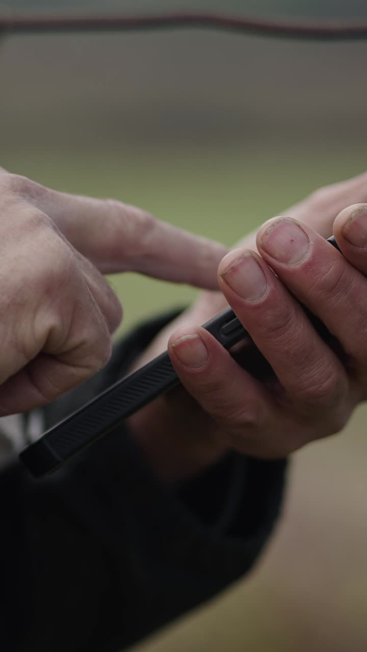 Hands holding and using a mobile phone