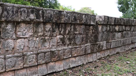 the platform of the skulls (tzompantli) detail of the bas-relief, at chichen itza archaeological site.