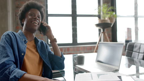 Happy-african-american-casual-businessman-talking-on-smartphone-at-home,-copy-space,-slow-motion