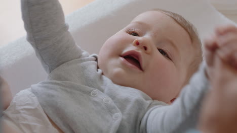 happy mother gently kissing baby enjoying loving mom playfully caring for toddler on changing table at home sharing connection with her newborn child healthy childcare